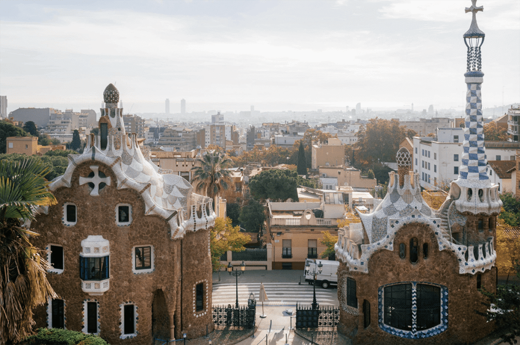 Iconic entrance of Park Güell in Barcelona with Gaudí’s colorful houses and panoramic city views